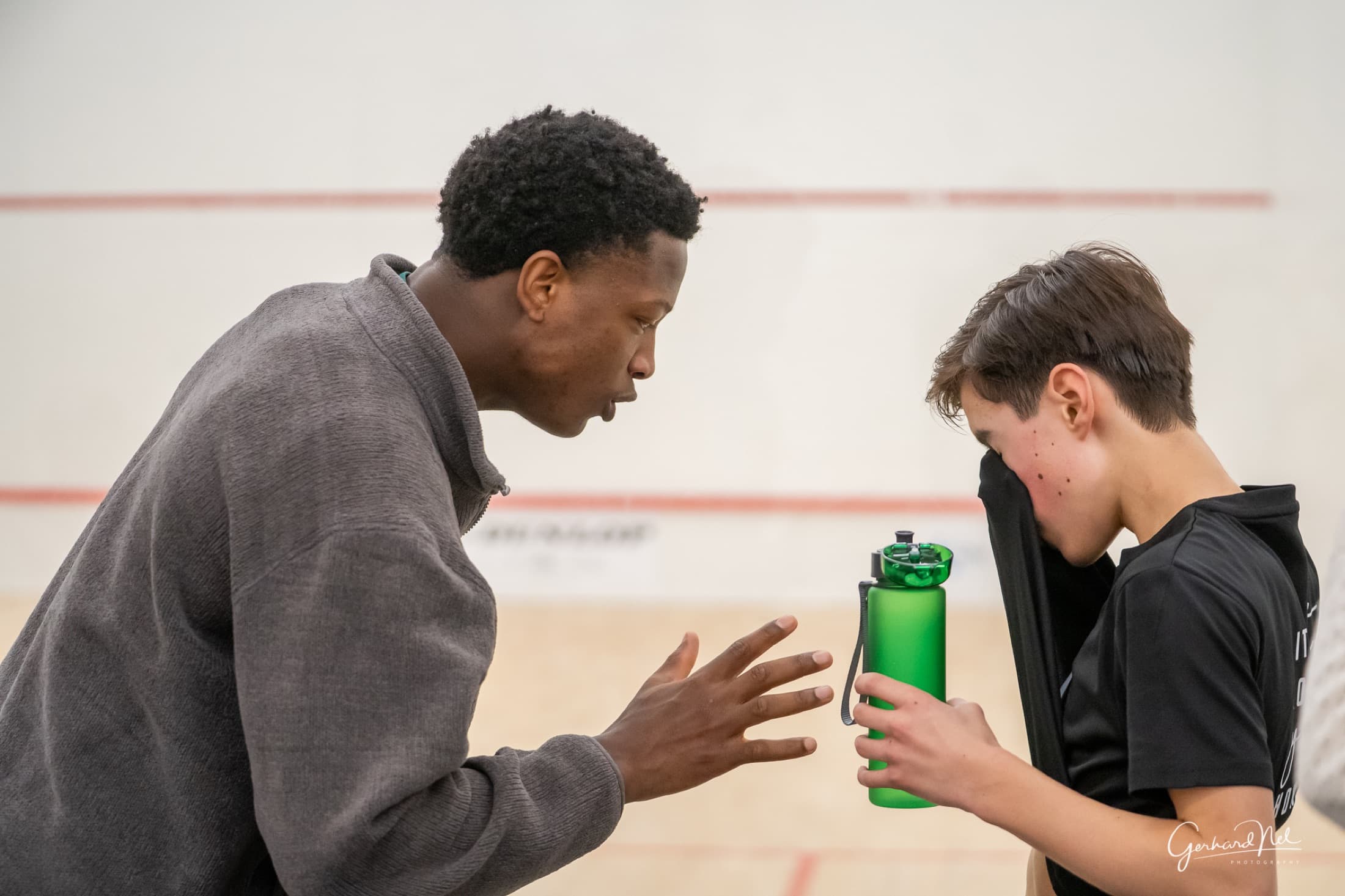Coach reviewing movement with players during an immersive camp session