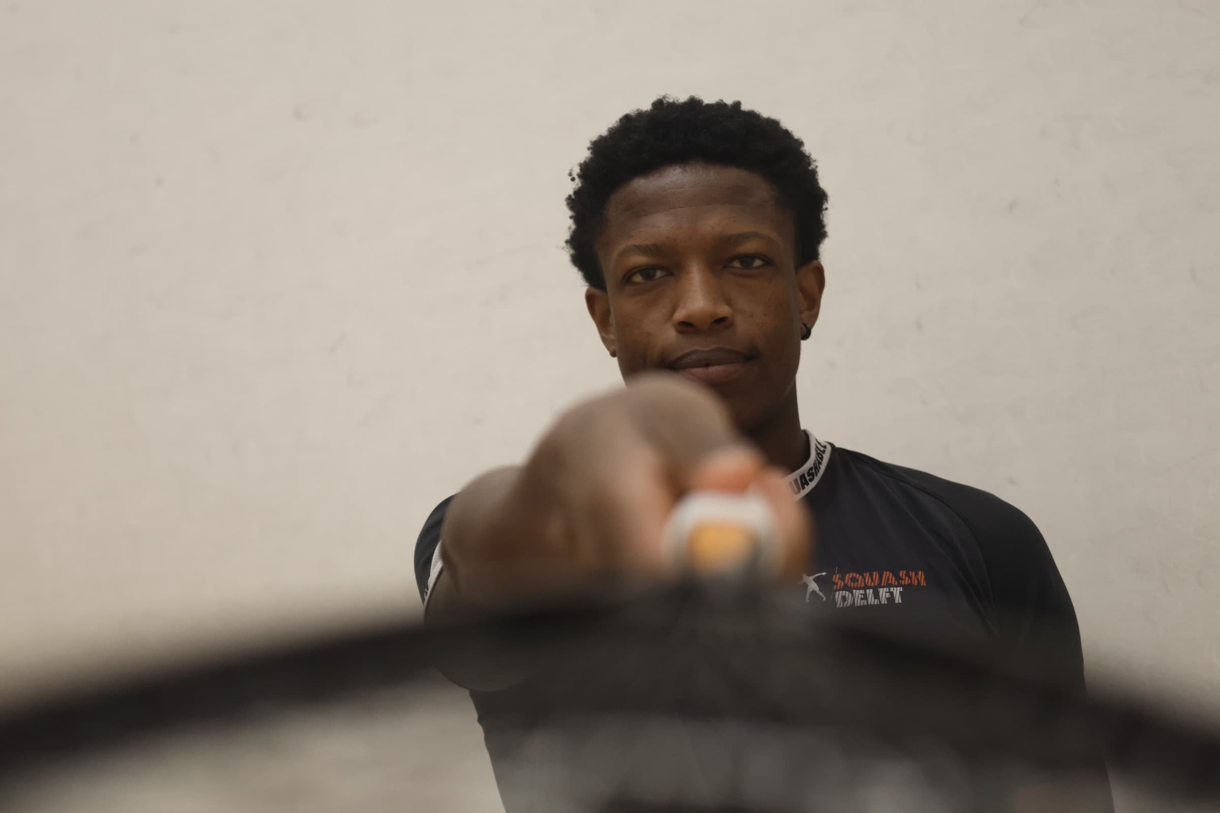 Squash player driving through a forehand during match play